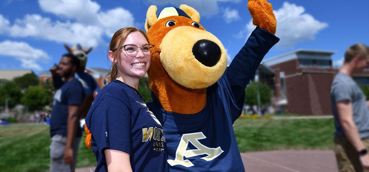 A transfer student with Zippy at The University of Akron hanging out on campus.